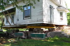 Raised house to place poured wall basement.